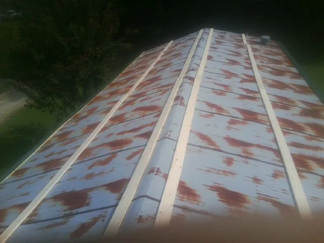 Rusted metal roof panels with new wood purlins before replacement — Storm Damage Roof Repair in Mercer by Roofing Brothers